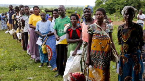 Malawians queue for food aid distributed by the United Nations World Food Program (WFP)